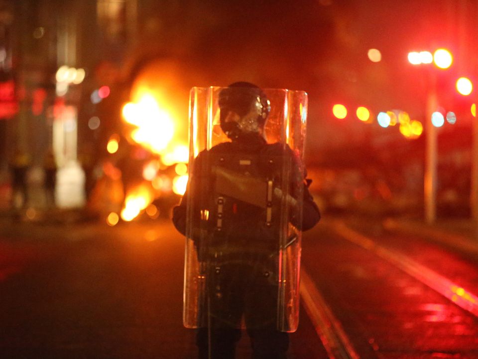 A garda in riot gear on O'Connell Street. Photo: Stephen Collins/Collins Dublin