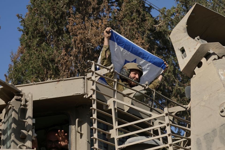 A convoy of Israeli army vehicles near Israel’s border after leaving Gaza on Friday (Tsafrir Abayov/AP)