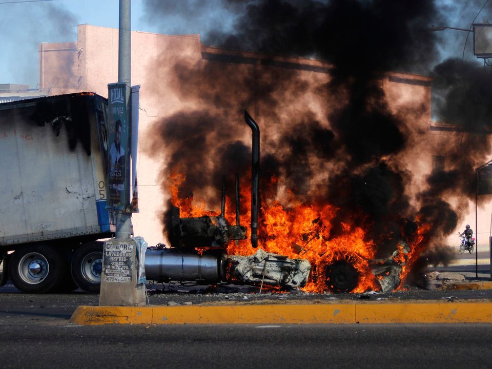 A truck burns on a street in Culiacan, Sinaloa state, Mexico, in response to the arrest of alleged drug trafficker Ovidio Guzmán. Photo: Martin Urista/AP