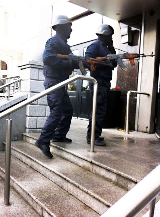 Gunmen hold the AKs that were found in a car the day after the Regency killing